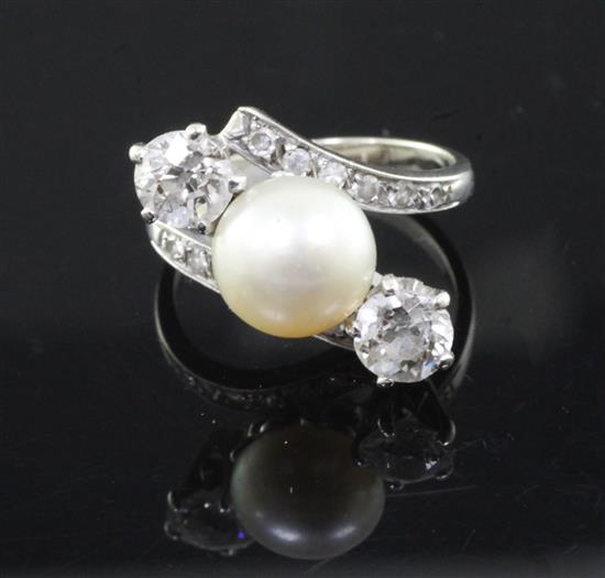 A white gold, natural pearl and two stone diamond crossover ring, size K.